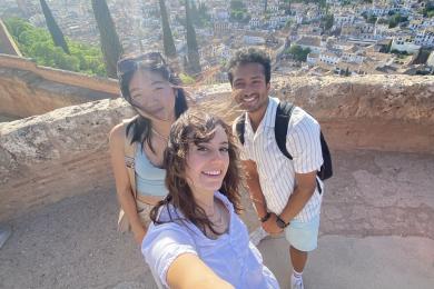 Three students taking a selfie on an overlook in Granada